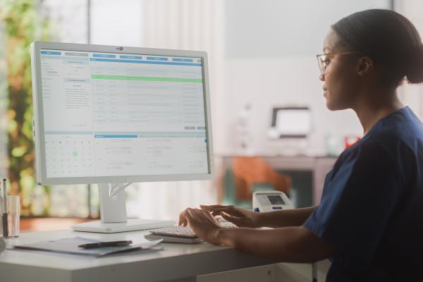 Medical professional looking at desktop screen